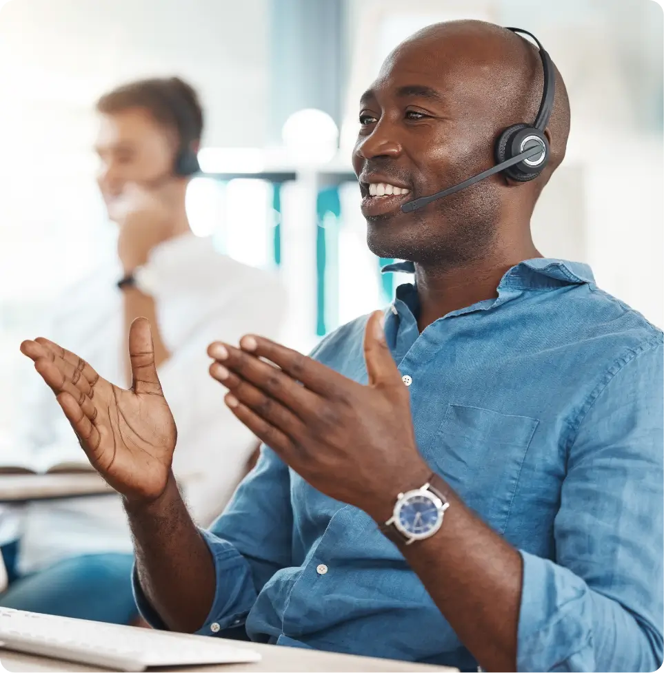 Male account representative speaking with clients and wearing a headset