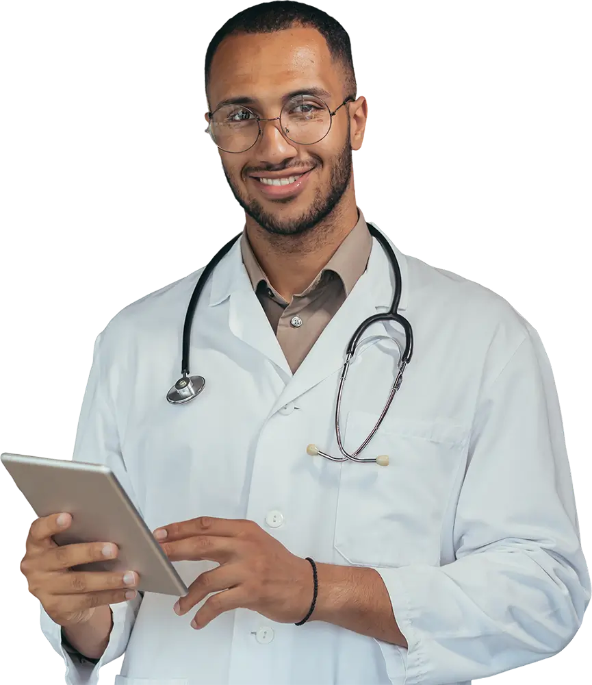 A male doctor, dressed in a white coat, examines a tablet, indicating a modern approach to healthcare.