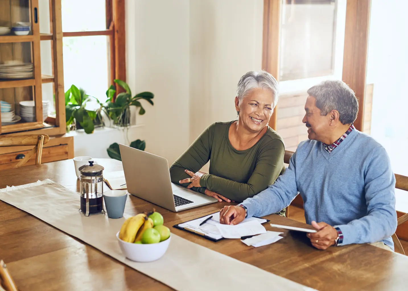 Elderly couple paying finances online