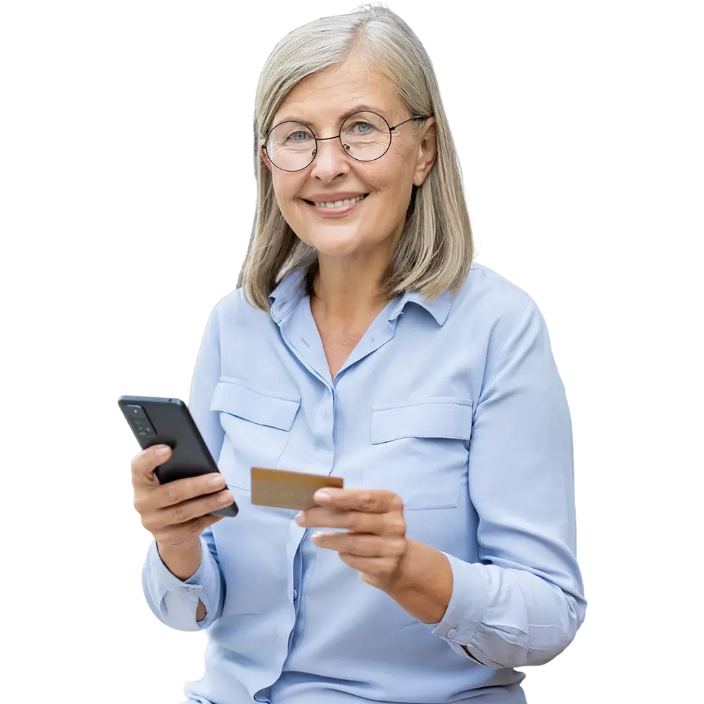 Woman holding a credit card and making an online purchase through her mobile phone