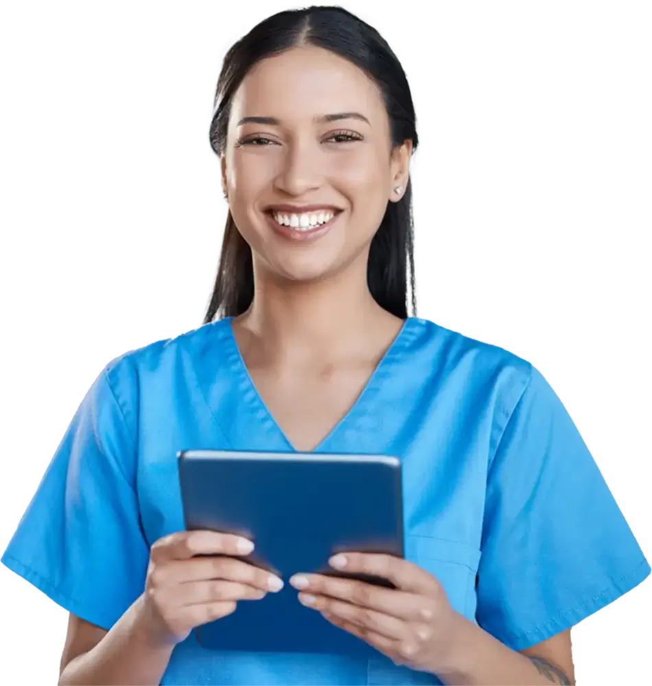 a woman in blue scrubs holding a tablet