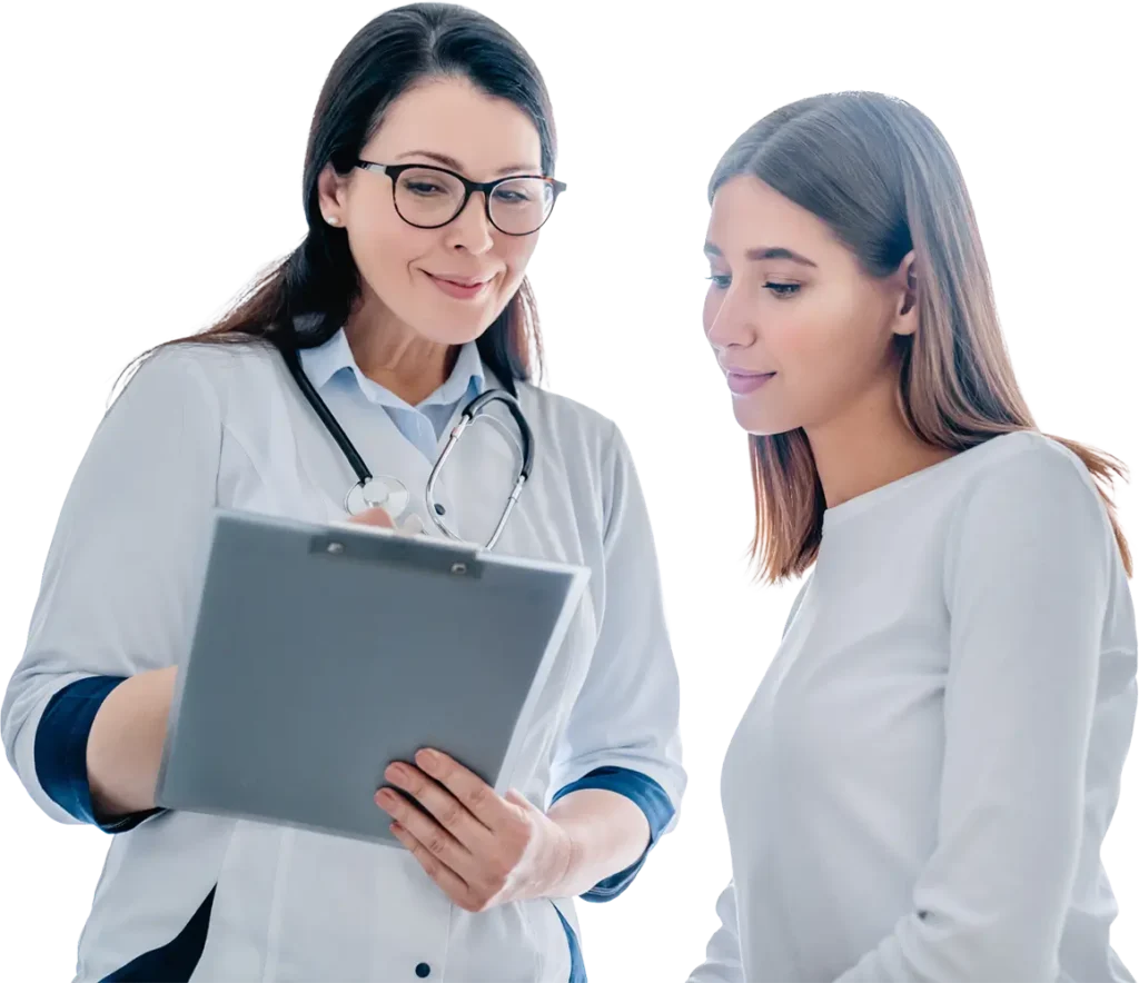A female doctor is engaged in conversation with a patient in a clinical setting.