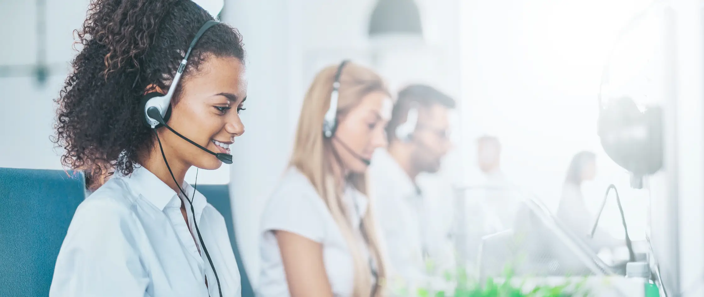 A woman with a headset in a call center, attentively handling calls and assisting clients.